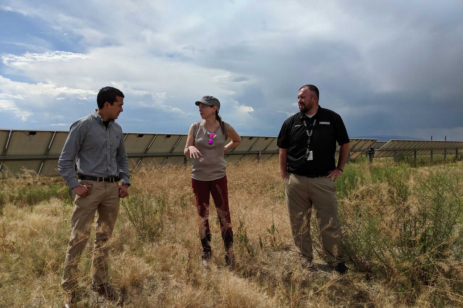 astrid from camus in a solar field with utility representatives